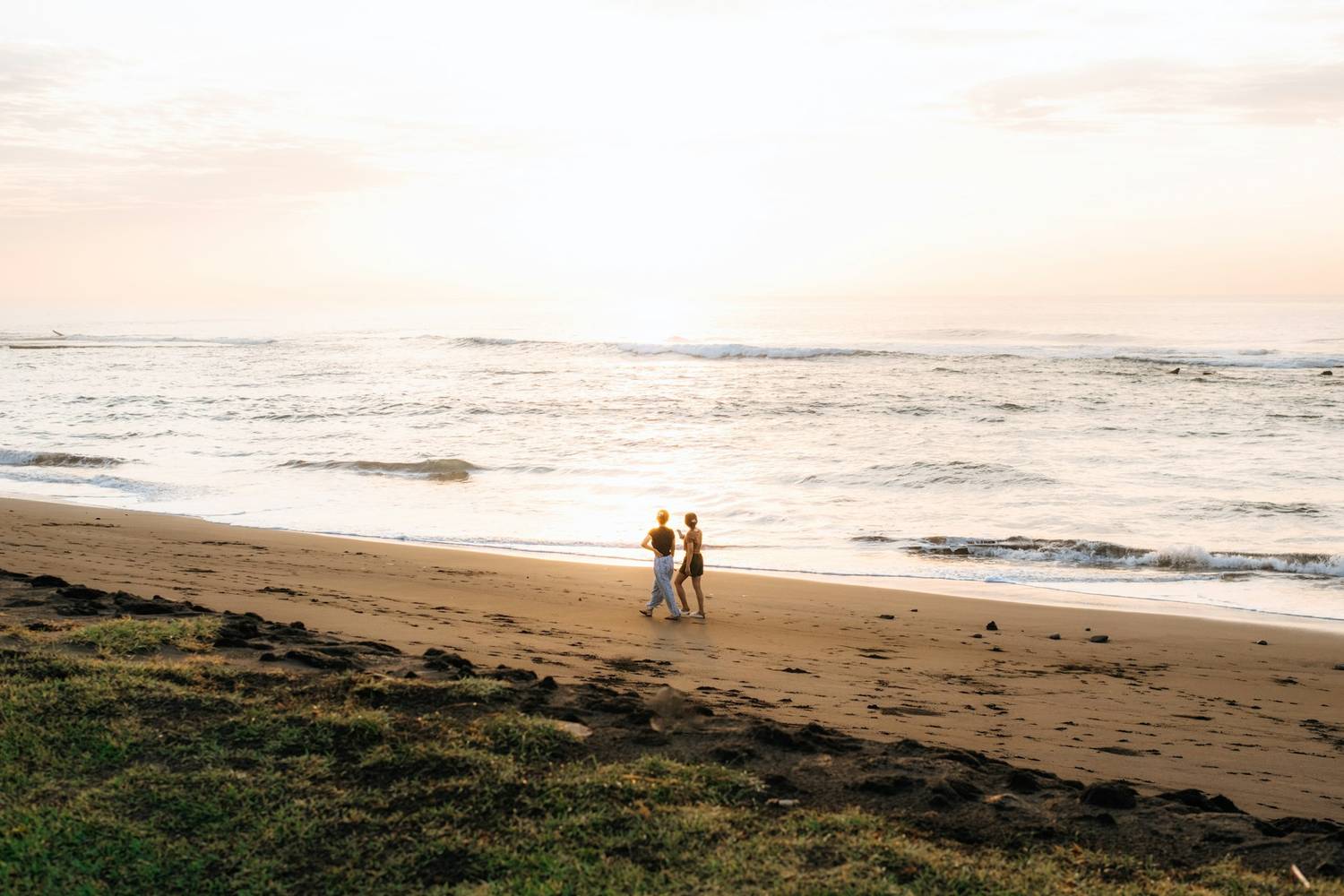 A couple photographed on the beach at golden hour